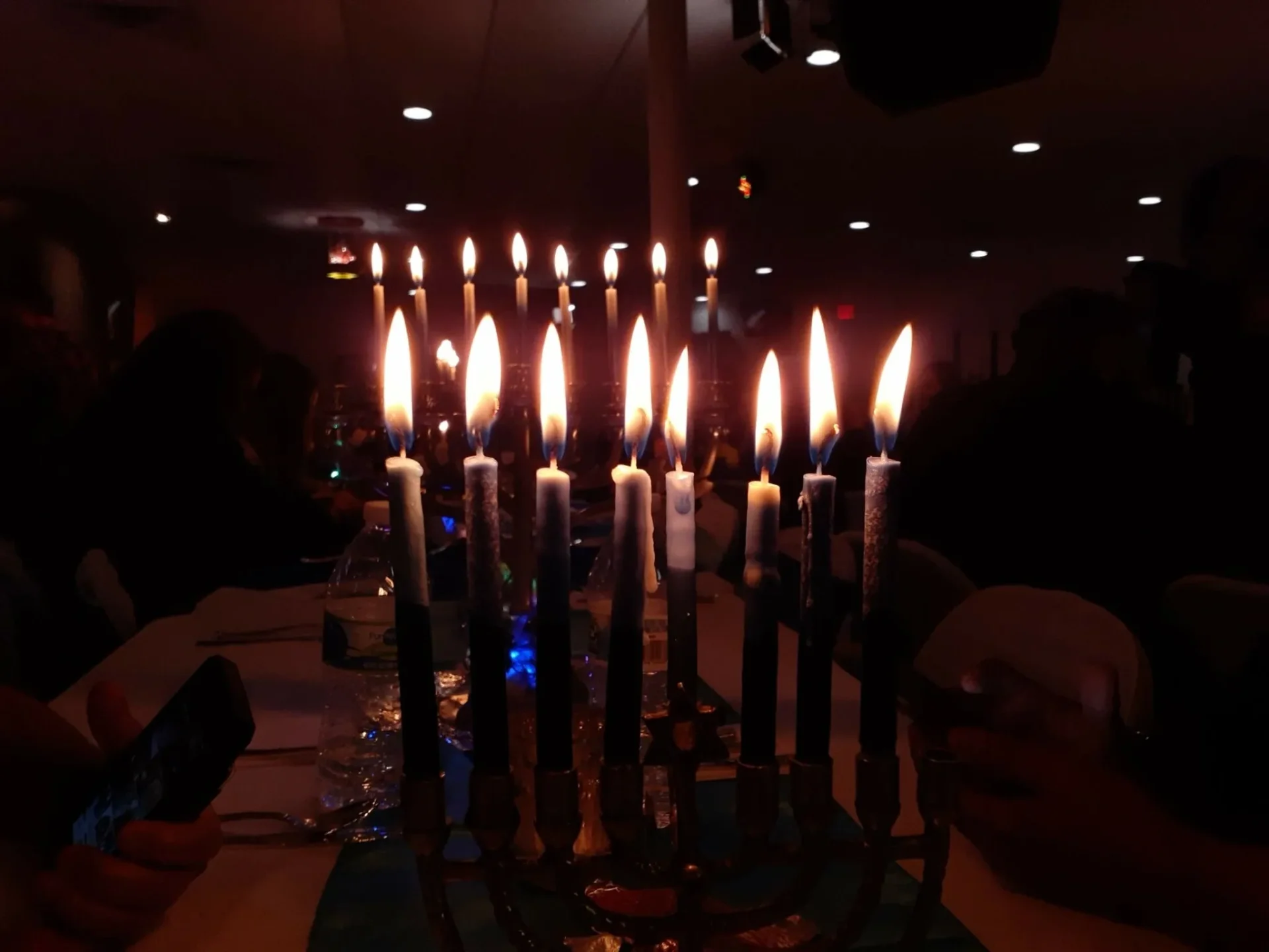A group of candles lit up in the dark.