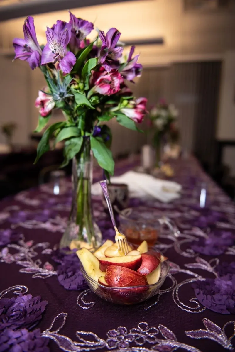 A table with flowers and fruit on it