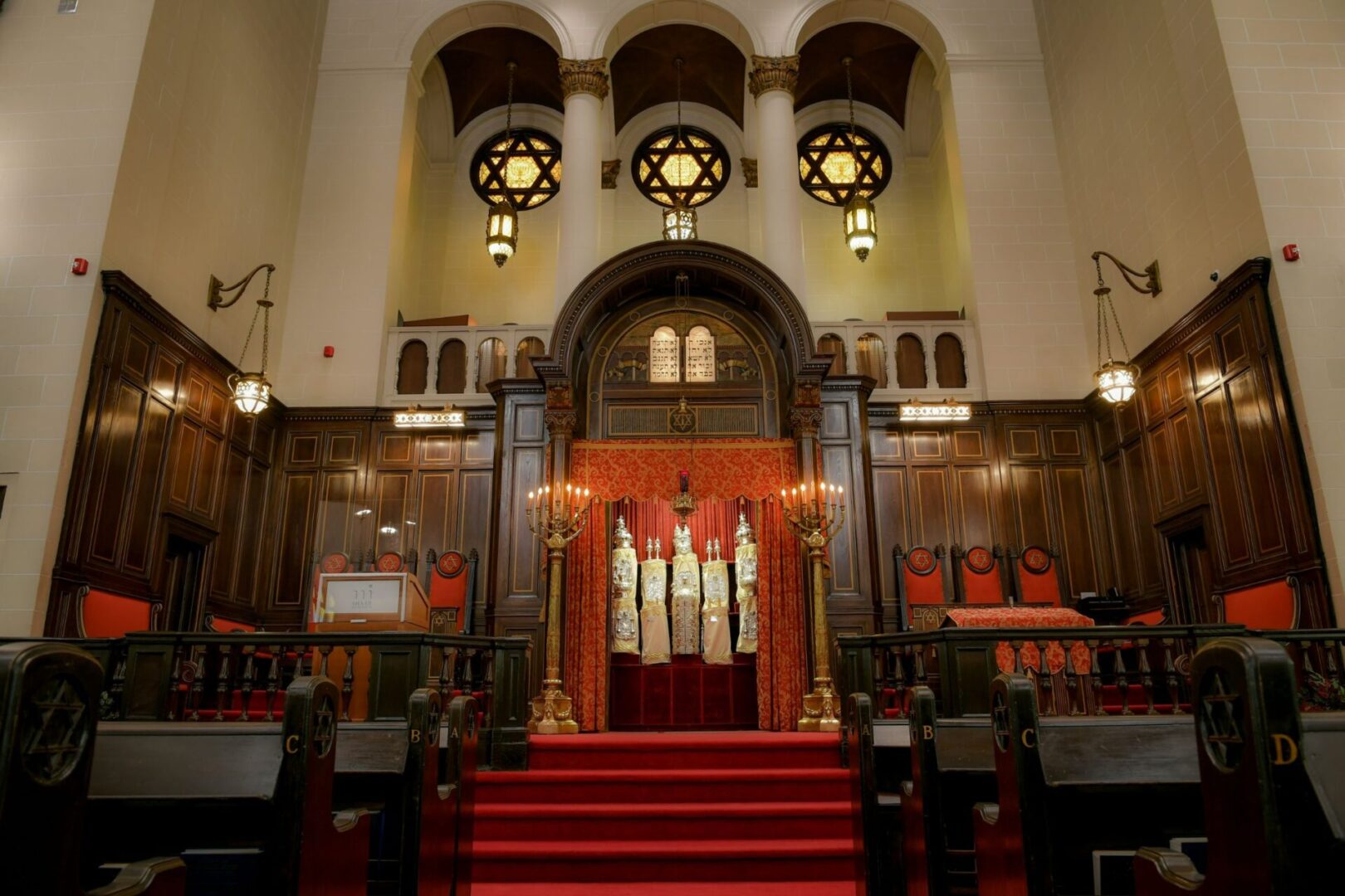 A church with red carpet and stairs leading to the entrance.