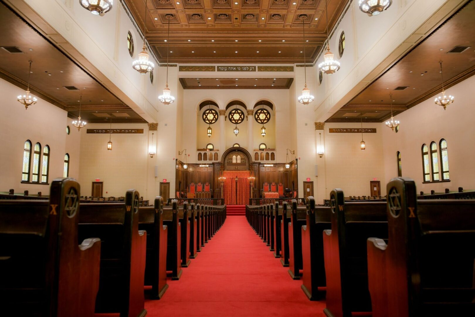 A church with red carpet and pews in it