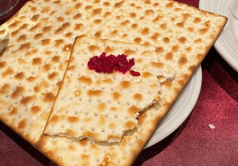 A square matzah with one slice cut out of it.